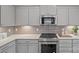 Well-equipped kitchen featuring stainless steel appliances, including a built-in microwave and sleek countertops at 10033 Guardian Dr # 265, Charlotte, NC 28273