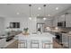 Modern kitchen with an island with clear bar stools, stainless steel appliances, and an open layout to living space at 10033 Guardian Dr # 265, Charlotte, NC 28273