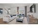 Bright living room features hardwood floors, neutral decor, and a view of the neighborhood at 10033 Guardian Dr # 265, Charlotte, NC 28273