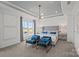 Spacious main bedroom showcases a tray ceiling, sitting area, and serene views from the window at 10033 Guardian Dr # 265, Charlotte, NC 28273