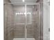 Modern shower enclosed in glass features sleek tile work, rainfall shower head, and built-in shelving at 10033 Guardian Dr # 265, Charlotte, NC 28273