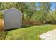 Backyard featuring a shed, and a fenced-in yard with mature trees, offering privacy and space at 10937 Dry Stone Dr, Huntersville, NC 28078