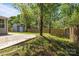 Backyard featuring a shed, and a fenced-in yard with mature trees, offering privacy and space at 10937 Dry Stone Dr, Huntersville, NC 28078