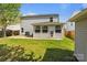 A well-maintained backyard features a grassy area, a patio, and an enclosed porch at 10937 Dry Stone Dr, Huntersville, NC 28078