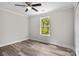 Bedroom featuring neutral walls, and a ceiling fan, flooded with natural light from the large window at 10937 Dry Stone Dr, Huntersville, NC 28078