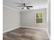 Neutral bedroom offers natural light, ceiling fan and wood-look flooring at 10937 Dry Stone Dr, Huntersville, NC 28078
