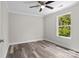 Bedroom featuring neutral walls, and a ceiling fan, flooded with natural light from the large window at 10937 Dry Stone Dr, Huntersville, NC 28078