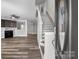 Welcoming entryway with hardwood floors, staircase, and an open view of the living room with a fireplace at 10937 Dry Stone Dr, Huntersville, NC 28078