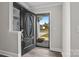 View through the open front door featuring hardwood floors, coat rack, and exterior landscaping at 10937 Dry Stone Dr, Huntersville, NC 28078