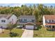Traditional two-story home with a brick-accented garage and a welcoming front porch at 10937 Dry Stone Dr, Huntersville, NC 28078