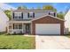 Charming two-story home with gray siding, brick accents, a covered porch, and a two-car garage at 10937 Dry Stone Dr, Huntersville, NC 28078