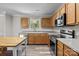 Bright kitchen features stainless steel appliances, light wood cabinets and modern countertops at 10937 Dry Stone Dr, Huntersville, NC 28078