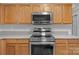 Contemporary kitchen with stainless steel appliances, including a stove, oven, and overhead microwave at 10937 Dry Stone Dr, Huntersville, NC 28078