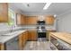 Bright kitchen features stainless steel appliances, light wood cabinets and modern countertops at 10937 Dry Stone Dr, Huntersville, NC 28078