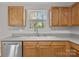 The kitchen offers stainless appliances, solid surface countertops, tile backsplash, and a garden view window at 10937 Dry Stone Dr, Huntersville, NC 28078