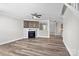 Bright living room boasts luxury vinyl flooring, a ceiling fan, and a fireplace with a custom wood mantel at 10937 Dry Stone Dr, Huntersville, NC 28078