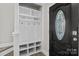 Welcoming mudroom features built-in storage with hooks and shelves next to a glass-paneled front door at 10937 Dry Stone Dr, Huntersville, NC 28078