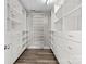 Spacious walk-in closet with custom shelves, drawers, and hanging rods for optimal storage at 10937 Dry Stone Dr, Huntersville, NC 28078