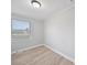 This bedroom features neutral walls, base trim, and wood-look floors, plus a window at 1142 Mona Dr, Charlotte, NC 28206