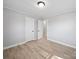 This bedroom features neutral walls, base trim, and wood-look floors at 1142 Mona Dr, Charlotte, NC 28206