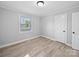 This bedroom features neutral walls, base trim, and wood-look floors, plus a window at 1142 Mona Dr, Charlotte, NC 28206