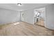 Neutral bedroom with new floors and fresh paint, showing view to the kitchen at 1142 Mona Dr, Charlotte, NC 28206