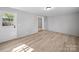 Neutral bedroom with new floors and fresh paint, showing view to a hallway at 1142 Mona Dr, Charlotte, NC 28206