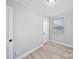 This bedroom features neutral walls, base trim, wood-look floors, and a window at 1142 Mona Dr, Charlotte, NC 28206