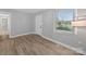 Spacious bedroom featuring modern wood-look flooring, neutral colors, and natural light at 1142 Mona Dr, Charlotte, NC 28206