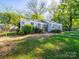 Charming home with a well-manicured lawn and lush landscaping in a tranquil setting at 1142 Mona Dr, Charlotte, NC 28206