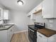 Modern kitchen with neutral cabinets, new floors, and new appliances at 1142 Mona Dr, Charlotte, NC 28206