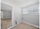 Laundry room features wood-look floors, neutral paint, and a large window for natural light at 1142 Mona Dr, Charlotte, NC 28206