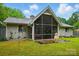 Exterior view of a home featuring a large screened porch and green backyard at 116 Pelham Ln, Fort Mill, SC 29715