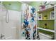 Bright bathroom featuring white shower with floral shower curtain, shelf and stylish decorations at 116 Pelham Ln, Fort Mill, SC 29715