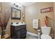 Cozy bathroom features a dark wood vanity with white countertop, framed mirror, and stylish decor at 116 Pelham Ln, Fort Mill, SC 29715