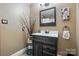 Bathroom featuring stylish dark wood vanity with white countertop, framed mirror and decorative accents at 116 Pelham Ln, Fort Mill, SC 29715