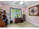 Bedroom featuring neutral walls, ceiling fan, artwork, a desk, and natural light from the window at 116 Pelham Ln, Fort Mill, SC 29715