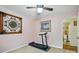 Bedroom with neutral walls and carpet includes a treadmill and access to an attached bathroom at 116 Pelham Ln, Fort Mill, SC 29715