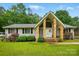 Charming home featuring a unique entryway with stone pillars and beautifully landscaped front yard at 116 Pelham Ln, Fort Mill, SC 29715
