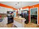 Updated kitchen with stainless steel appliances, white cabinets, granite countertops, and a portable island at 116 Pelham Ln, Fort Mill, SC 29715
