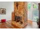 Living room showcasing a large stone fireplace, hardwood floors, and natural light at 116 Pelham Ln, Fort Mill, SC 29715