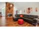 Cozy living room featuring a stone fireplace, large windows, and hardwood floors at 116 Pelham Ln, Fort Mill, SC 29715