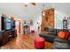 Bright open concept living room with a stone fireplace, vaulted ceilings, and hardwood floors at 116 Pelham Ln, Fort Mill, SC 29715