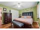 Well-lit bedroom with a dark wood bed frame, bench, and ample storage space at 116 Pelham Ln, Fort Mill, SC 29715