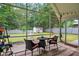 Relaxing screened porch featuring outdoor seating and a view of the well-maintained backyard and shed at 116 Pelham Ln, Fort Mill, SC 29715
