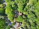 An aerial view of the home surrounded by mature trees in a lush landscape at 11914 Rock Canyon Dr, Charlotte, NC 28226
