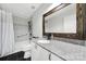 Well-lit bathroom featuring modern fixtures, a granite countertop, and a bathtub with shower at 11914 Rock Canyon Dr, Charlotte, NC 28226
