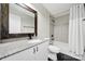Well-lit bathroom featuring modern fixtures, a granite countertop, and a bathtub with shower at 11914 Rock Canyon Dr, Charlotte, NC 28226