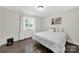 Comfortable bedroom with a bright window, hardwood floors, and warm decor at 11914 Rock Canyon Dr, Charlotte, NC 28226
