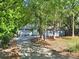 View of the home exterior with an ample driveway surrounded by mature trees at 11914 Rock Canyon Dr, Charlotte, NC 28226
